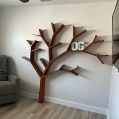 a living room with a tree shaped book shelf