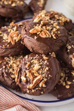 chocolate cookies with pecans and nuts on a plate