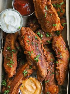 chicken wings with dipping sauces in a box