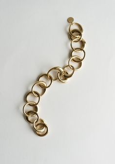 Laura Bracelet in Gold from Lie Studio. Chunky but elegant bracelet is made from gold-plated brass. Assorted rings looped together, adjustable length. Need a second opinion? If you have special requests or just need advice, please reach out to hello@shop-vestige.com. 18k Gold Plated Brass. Handcrafted in Copenhagen Yellow Gold Link Bracelet In Brass, Timeless Gold Brass Bracelets, Gold-tone Brass Bracelets With Solid Link, Luxury Brass Bracelet With Adjustable Chain, Luxury Brass Bracelets With Adjustable Chain, Gold-tone Oval Link Brass Bracelet, Gold-tone Brass Link Bracelet, Elegant Oval Link Brass Chain Bracelet, Elegant Gold Link Bracelet In Brass