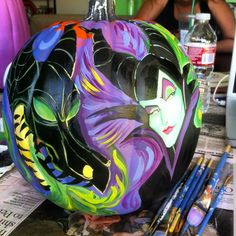 a painted pumpkin sitting on top of a table