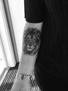 a man with a lion tattoo on his arm