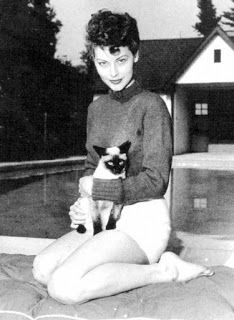 black and white photograph of a woman holding a cat