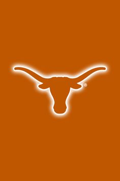 the longhorns logo is shown on an orange background with white light coming from it