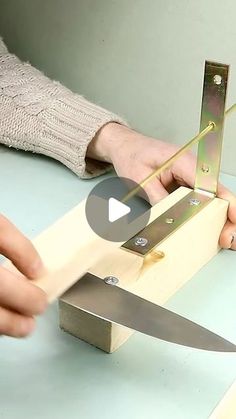 a person is using a knife to cut something out of a piece of plywood