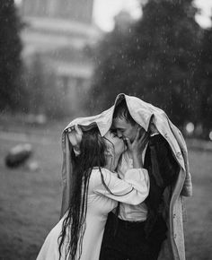 a man and woman kissing in the rain