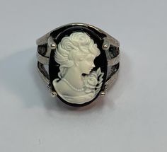 Very pretty large vintage ring in blackened silver metal, Depicting a modernized white cameo, beautifully crafted, the cameo is made of synthetic plastic. Ring of good quality, pretty fantasy. Size: 51EUR / 16.3mm In very good vintage condition. Note slight marks on the metal, particularly at the back of the ring and inside. Beautiful worn effect. Vintage Black Cameo Ring, Antique White Cameo Rings, White Cameo Collectible Rings, Collectible White Cameo Rings, Formal Silver Cameo Rings, Formal White Cameo Rings, Victorian Silver Cameo Rings, Plastic Ring, Cameo Ring