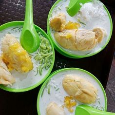 three green bowls filled with food on top of a table