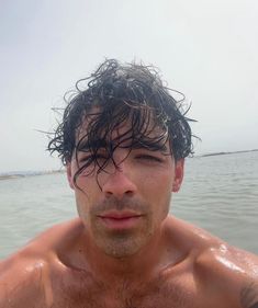 a man with wet hair standing in the water