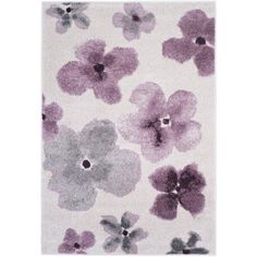 a white rug with purple and gray flowers on the front, along with an area rug in the middle