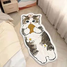 a cat rug is on the floor next to a bed