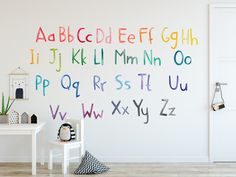 a child's room with colorful letters on the wall