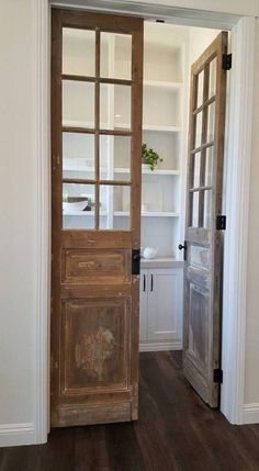 an open wooden door in a white room