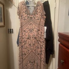 a dress hanging on a clothes rack in a closet