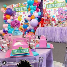 a table set up for a party with balloons and decorations