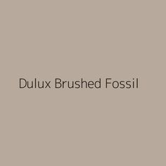 the words dulux brushed fossil on a gray background with black and white lettering