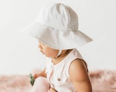 "Sun protection for baby and infants: This white floral eyelet, spring, summer, or vacation baby hat is made to keep the sun off your child's face in the summer sunshine. The perfect accessory for a spring wedding, family vacation, or as a beach hat; cotton and lightweight to dry quickly. Size Chart: Please double check sizing before placing your order😊 (If you would like a little grow room in the sunhat, please size up to the next size) 0-3 months// up to 17\" Head Circumference 6-12 months// Head Circumference of 17.5\" 12-24 months// Head Circumference of 18\"- 19.5\" 2-4 years// Head Circumference of 21\" (based on approximate national averages) *Measure around the most prominent part of your baby's forehead, just above the eyebrows, around the widest part of the back of the head. IF Newborn Sun Hat, Baby Sun Bonnet, Infant Hat, Wedding Casual, Travel Baby, Grow Room, Burp Rags, Baby Beach, Baby Boy Hats