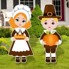 two children dressed up as pilgrim and witch holding pumpkins in front of a house