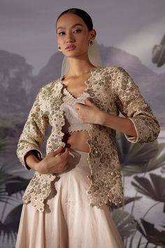 Ivory jacket with intricate floral embroidery. Paired with blouse and flared pant.
Component: 3
Pattern: Embroidery
Type Of Work: Floral
Neckline: V neck
Sleeve Type: Long sleeves
Fabric: Raw Silk, Dupion Silk
Color: Ivory
Other Details: 
Cutwork neckline
Note: Outfit worn by the model on left is not for sale
Occasion: Destination Wedding - Aza Fashions Elegant White Bandhgala For Spring, Elegant Long Sleeve Outerwear With Resham Embroidery, Festive Beige Long Sleeve Bandhgala, Elegant Beige Nehru Jacket With Intricate Embroidery, Cream Fitted Long Sleeve Nehru Jacket, Elegant Beige Nehru Jacket With Long Sleeves, Cream Long Sleeve Nehru Jacket For Festive Occasions, Cream Long Sleeve Party Sets, Elegant Beige Outerwear For Festive Season