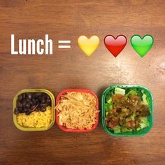 three plastic containers filled with food sitting on top of a wooden table next to hearts