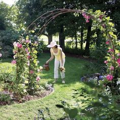 a woman watering flowers in her garden with the words hanuvman on it