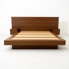 a bed with wooden slats on the headboard and foot board in front of it