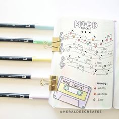 an open notebook with music notes and pencils