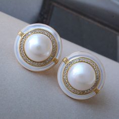 These stunning gold plated silver earrings feature a beautiful pair of hemisphere Mabe Pearl stones. With their intricate details and rich color, these push back studs are the perfect statement piece for any outfit. Handcrafted with care, these earrings are a true work of art and are sure to draw attention wherever you go. Whether you're looking for a unique gift or simply want to treat yourself. With their durable construction and timeless design, they're sure to become a beloved addition to yo Luxury Round Clip-on Earrings For Anniversary, White Clip-on Pearl Earrings Fine Jewelry, Timeless White Earrings For Anniversary, Elegant Round Earrings With High Luster, White Round Clip-on Earrings, Elegant High Luster Round Earrings, Silver Gold-plated Clip-on Earrings For Anniversary, Silver Gold Plated Clip-on Earrings For Anniversary, Luxury Round Clip-on Earrings For Wedding