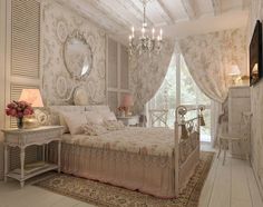 a bed room with a neatly made bed and a chandelier