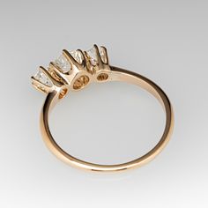 a gold ring with three diamonds on it