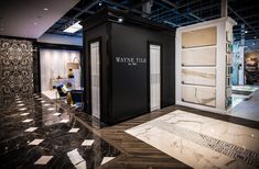 a room with black and white walls, marble flooring and decorative wall coverings