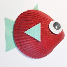 a red fish with a green arrow sticking out of it's side