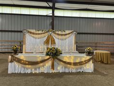 a white and gold decorated stage with sunflowers