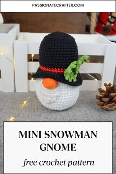 a crocheted snowman gnome sitting next to a pine cone with the text mini snowman gnome free crochet pattern