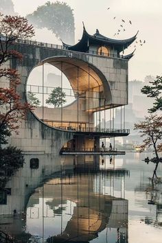 a building with a circular window next to water