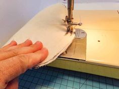 someone is using a sewing machine to sew something on the fabric that has been stitched together