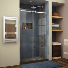 a bathroom with a walk in shower next to a towel rack