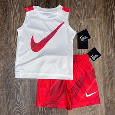 Tank Top Is Crew Neck, Dri-Fit, 100% Polyester, Nike Graphic On Chest. Shorts Are Pull-On, Elastic Waistband, 100% Polyester, Nike Logo Left Lower Leg. Nike White Summer Sets, White Nike Summer Sets, White Nike Playwear Sets, White Sports Sets For Summer, Red Sports Sets For Spring, Nike Sporty White Sets, Nike White Sets For Spring, White Sleeveless Sports Set, Nike Red Playwear Sets