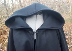 This short cloak is delightfully soft and comfortable. It's long enough to reach the back of the hand, keeping you warm but keeping your hands available when needed. It has a full hood and closes with your choice of matching cloth frog clasp or metal heart shaped clasp. This cloak is great for a costume piece or a cozy jacket, great for Spring, Fall, or over air conditioned buildings. Your cloak will measure about 30 inches in length. This listing is in black, but other colors are available in m Black Winter Cape For Outdoor, Black Winter Outdoor Cape, Black Winter Outerwear For Larp, Black Cape For Larp, Fitted Black Winter Cape, Black Fitted Winter Cape, Short Cloak, Cloak Black, Cape With Hood