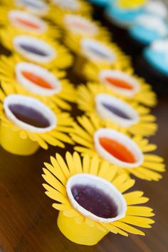 sunflower cups filled with jelly sit on a table