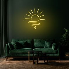 a living room with a green couch and a neon light on the wall above it