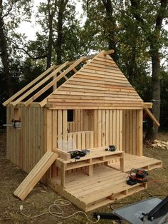 a small wooden house built in the woods