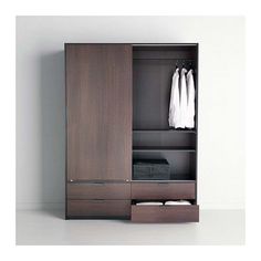 an open wardrobe with clothes hanging on the door and two drawers in front of it