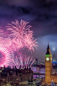 fireworks are lit up in the sky above big ben and the city of london, england