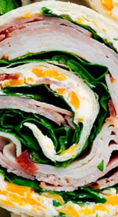 a sandwich with ham, cheese and spinach