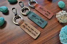 three leather keychains that say, you're mom and dad