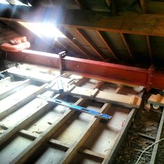 an attic with exposed wood and beams in place for the roof to be built into