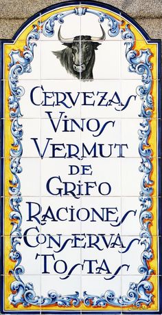 a tile sign with an image of a bull on it's face and the words cerveza vino vermut de grfio