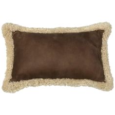 a brown and white pillow with sheep fur on the bottom, in front of a white background