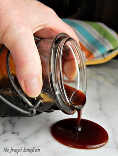 a person is pouring something into a jar